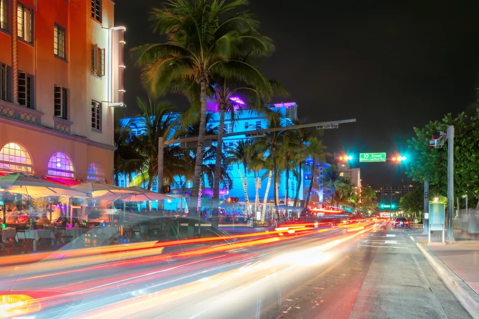 View of blurred traffic on South Beach, Miami street at nighttime.
